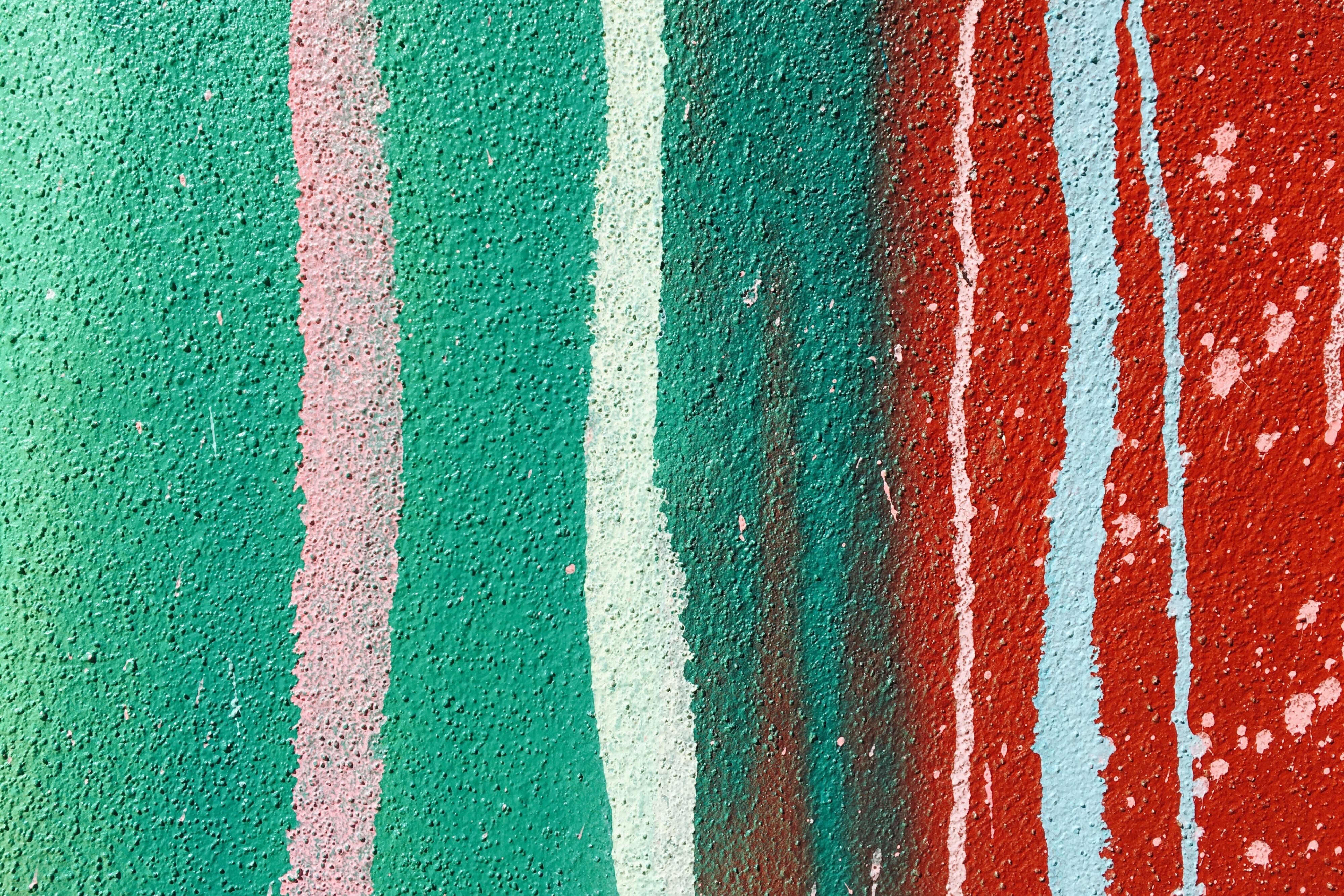 Green and red painting with colorful stripes