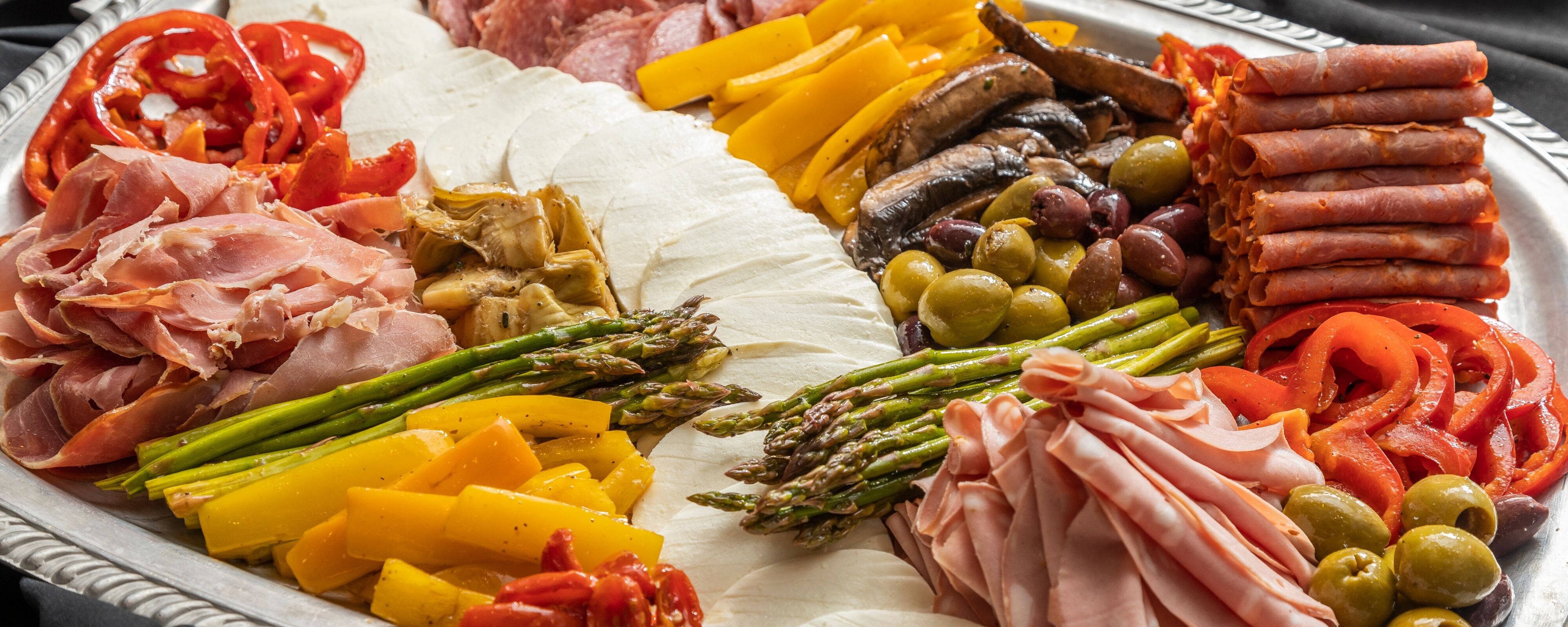 Platter of meats, cheeses, and vegetables