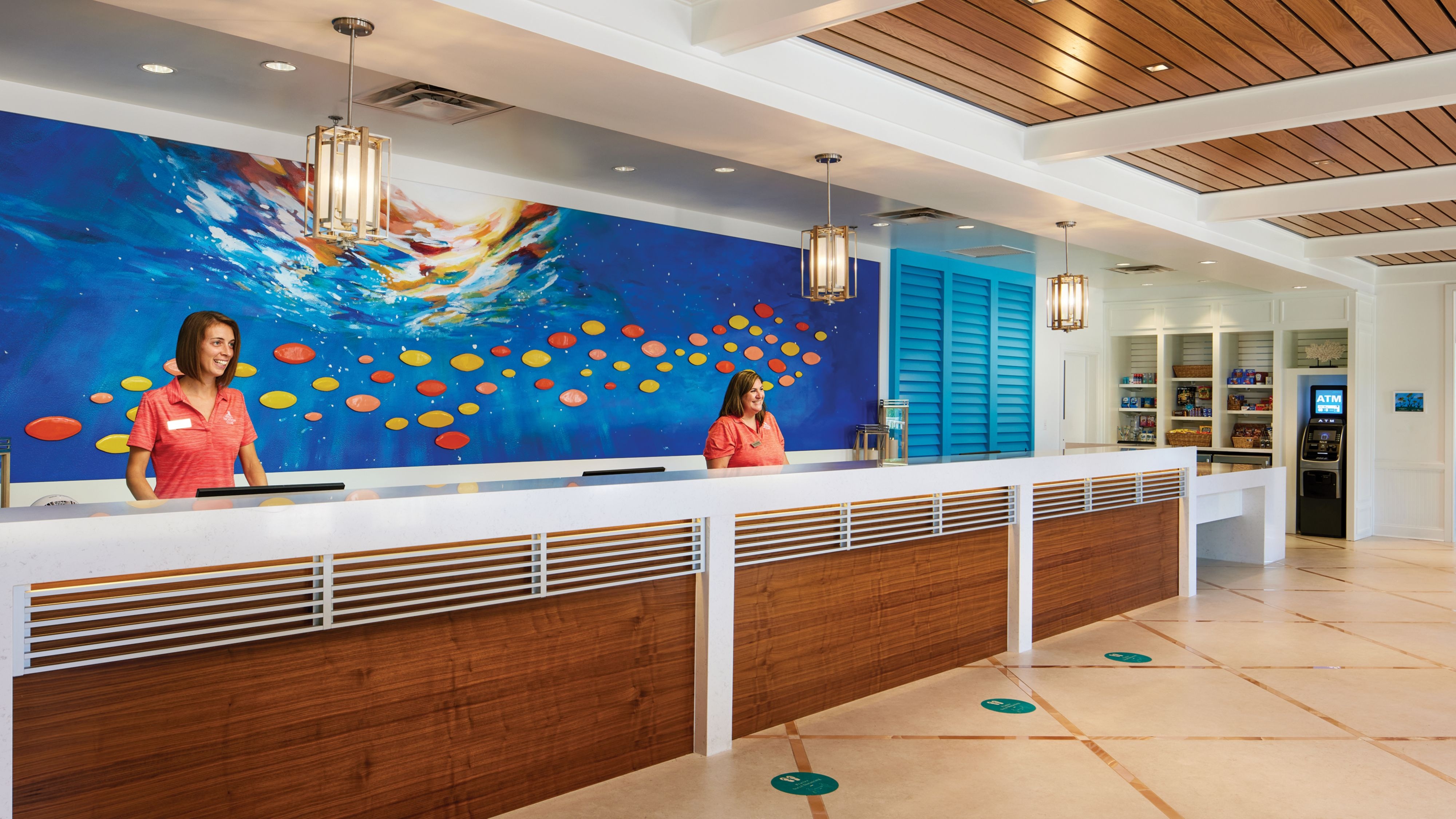 Two women standing behind front desk