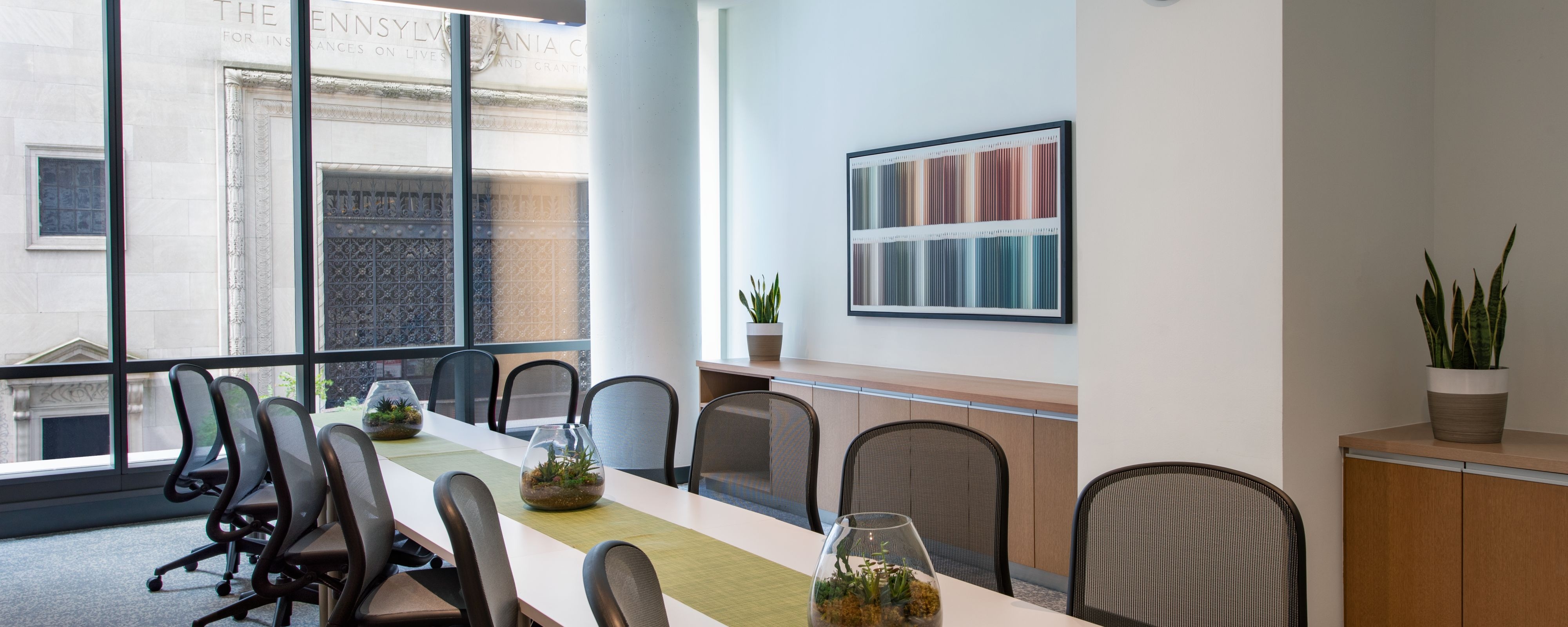 Meeting room setup in room with large exterior windows