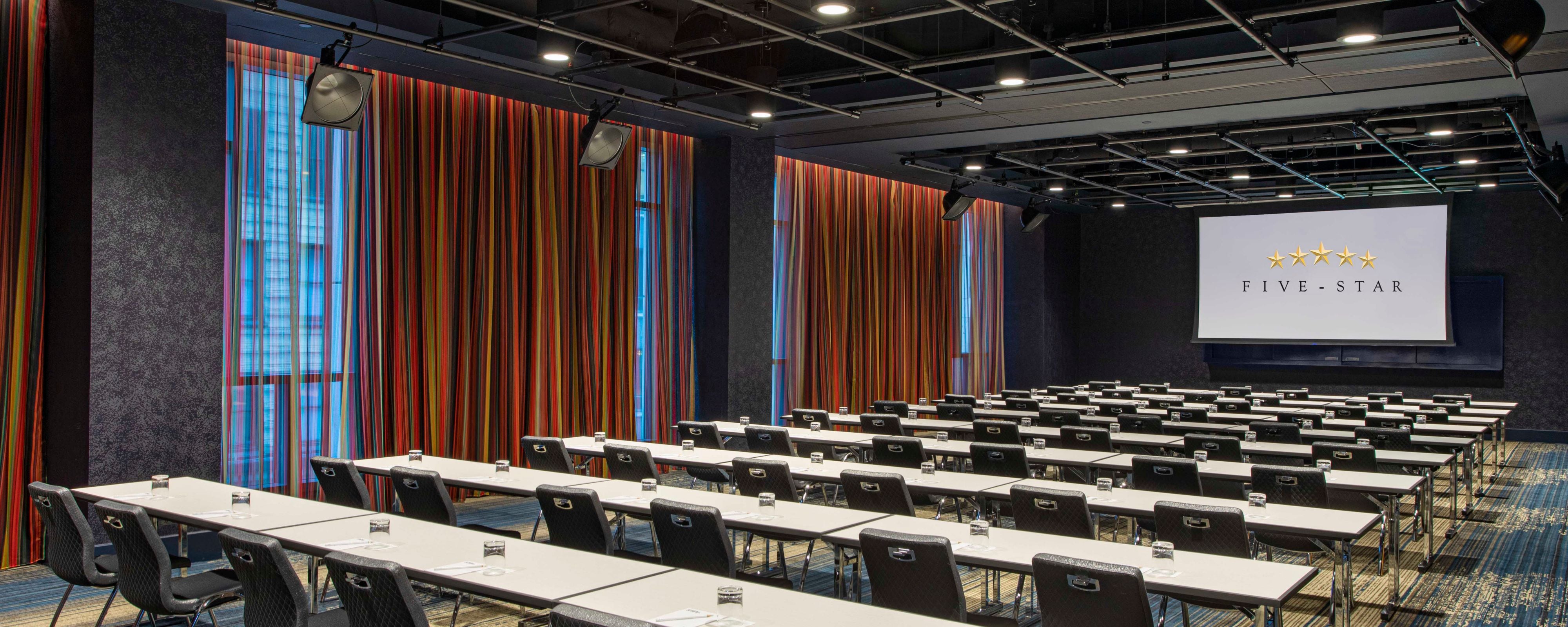 Meeting room setup in ballroom with large projector screen