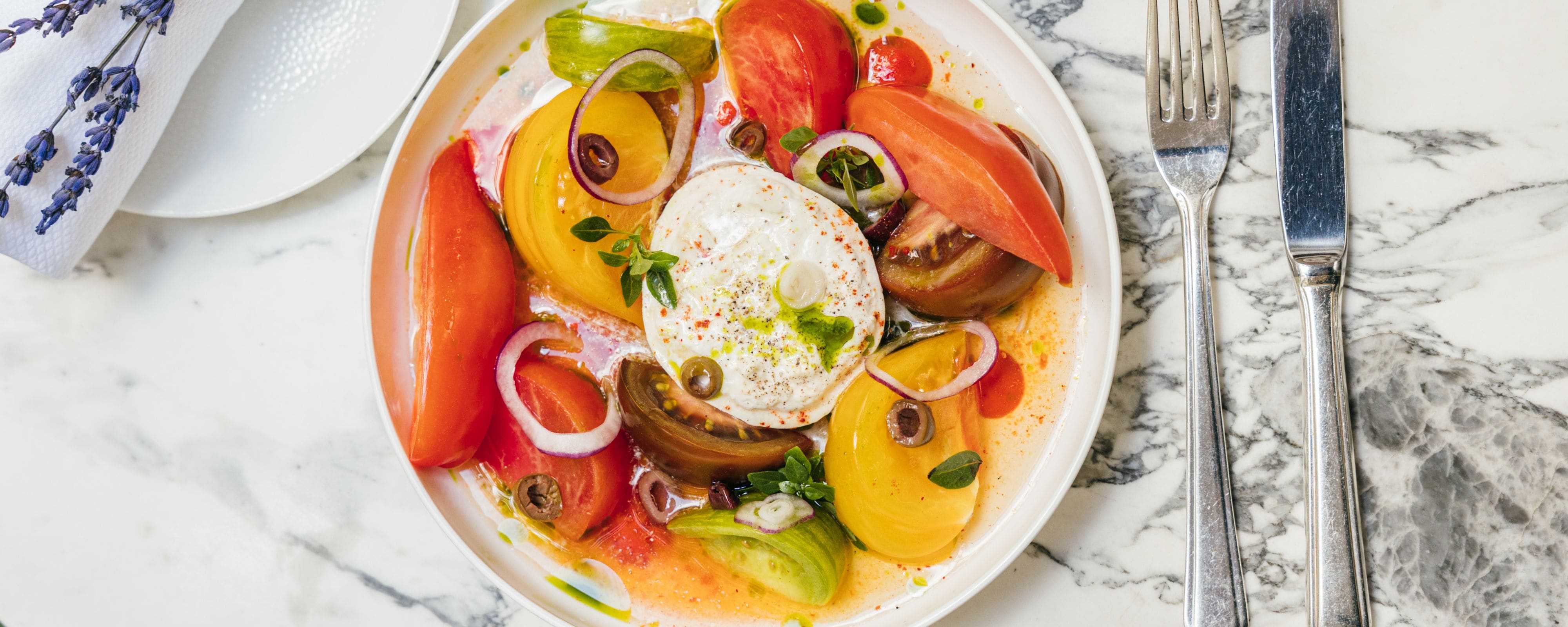 Person holding an appetizer next to soup