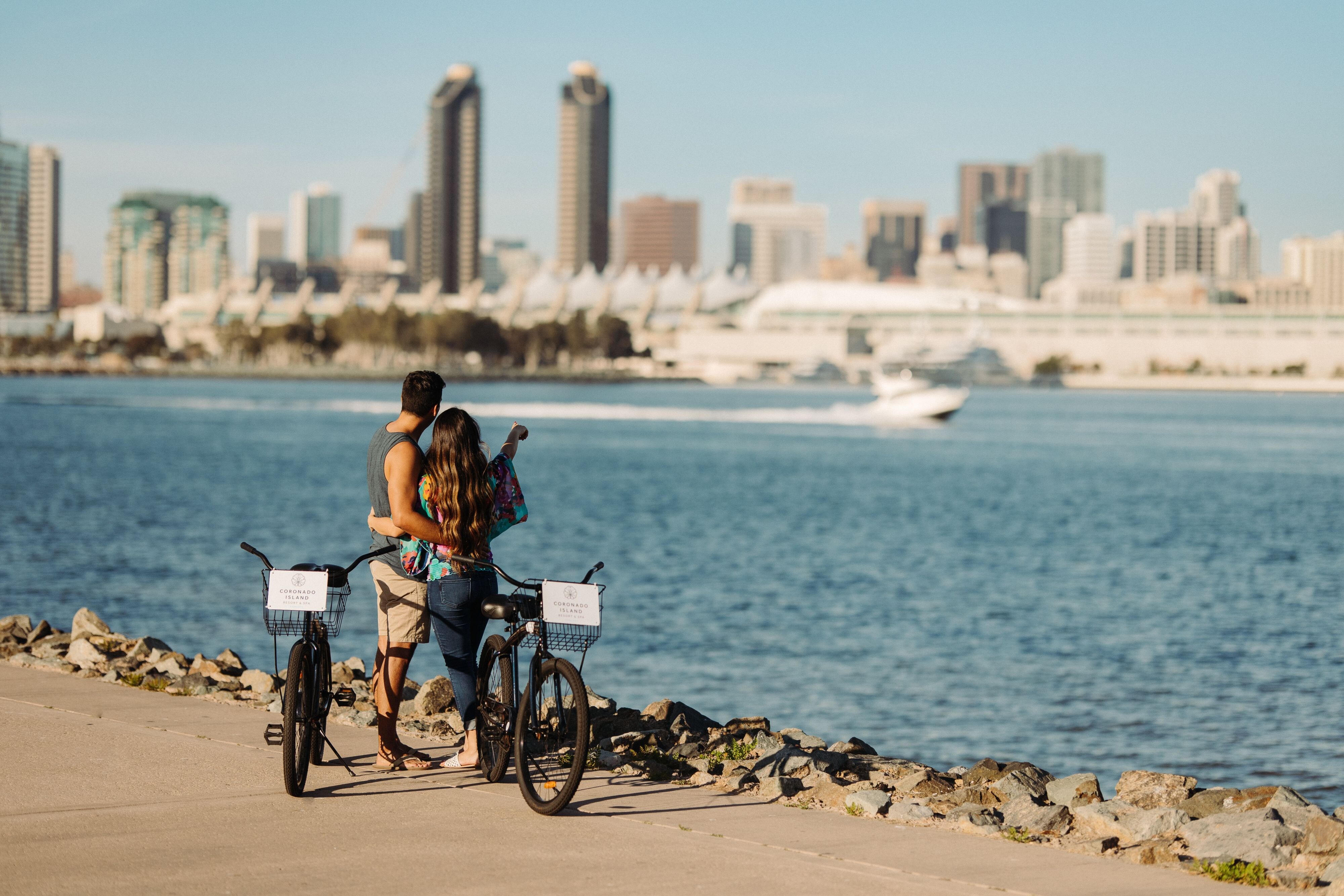 Couple looking at San Diego Skyline from boardwalk