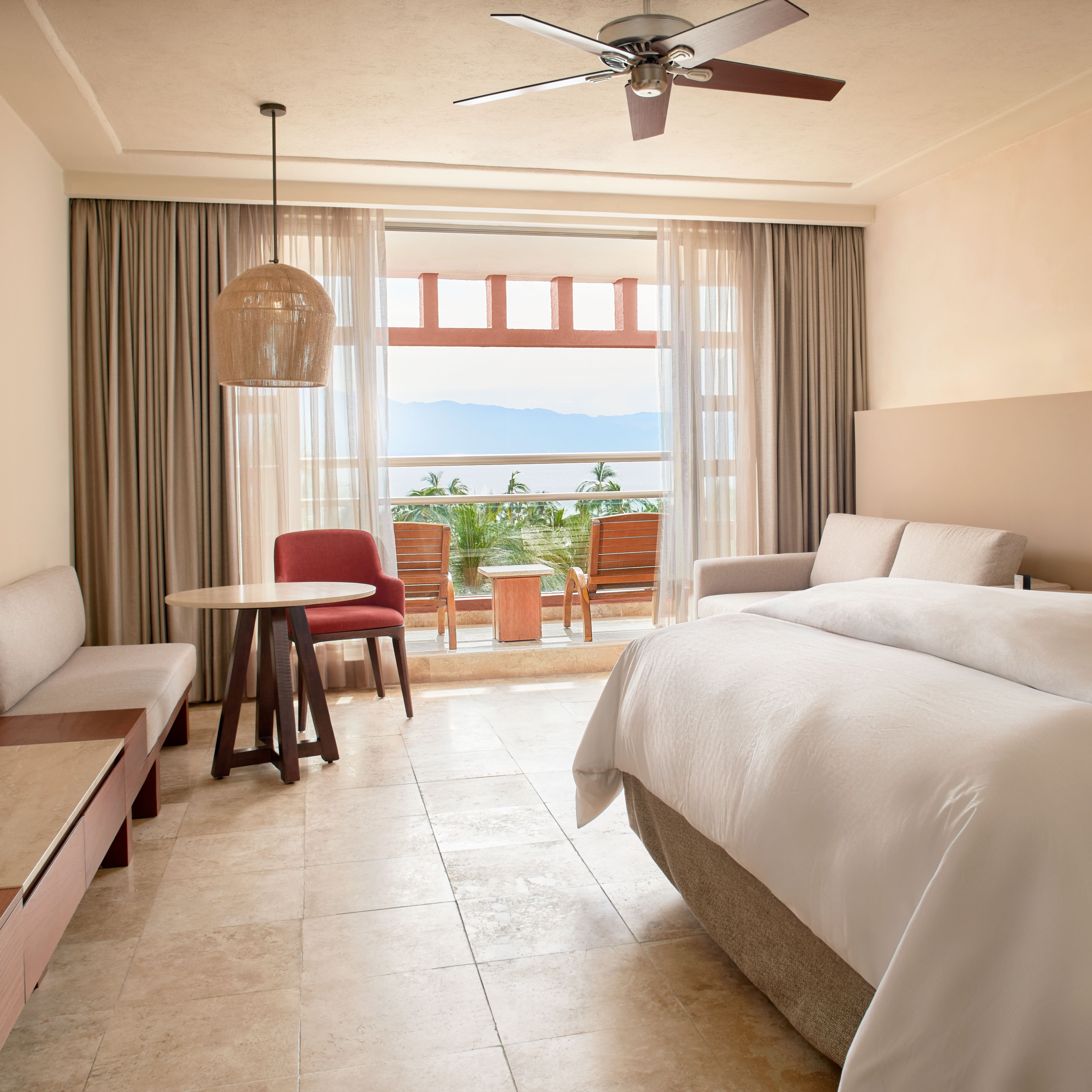 Guest bedroom with balcony looking over ocean
